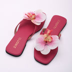Stylish pink sandals with comfy sole and open-toe design.