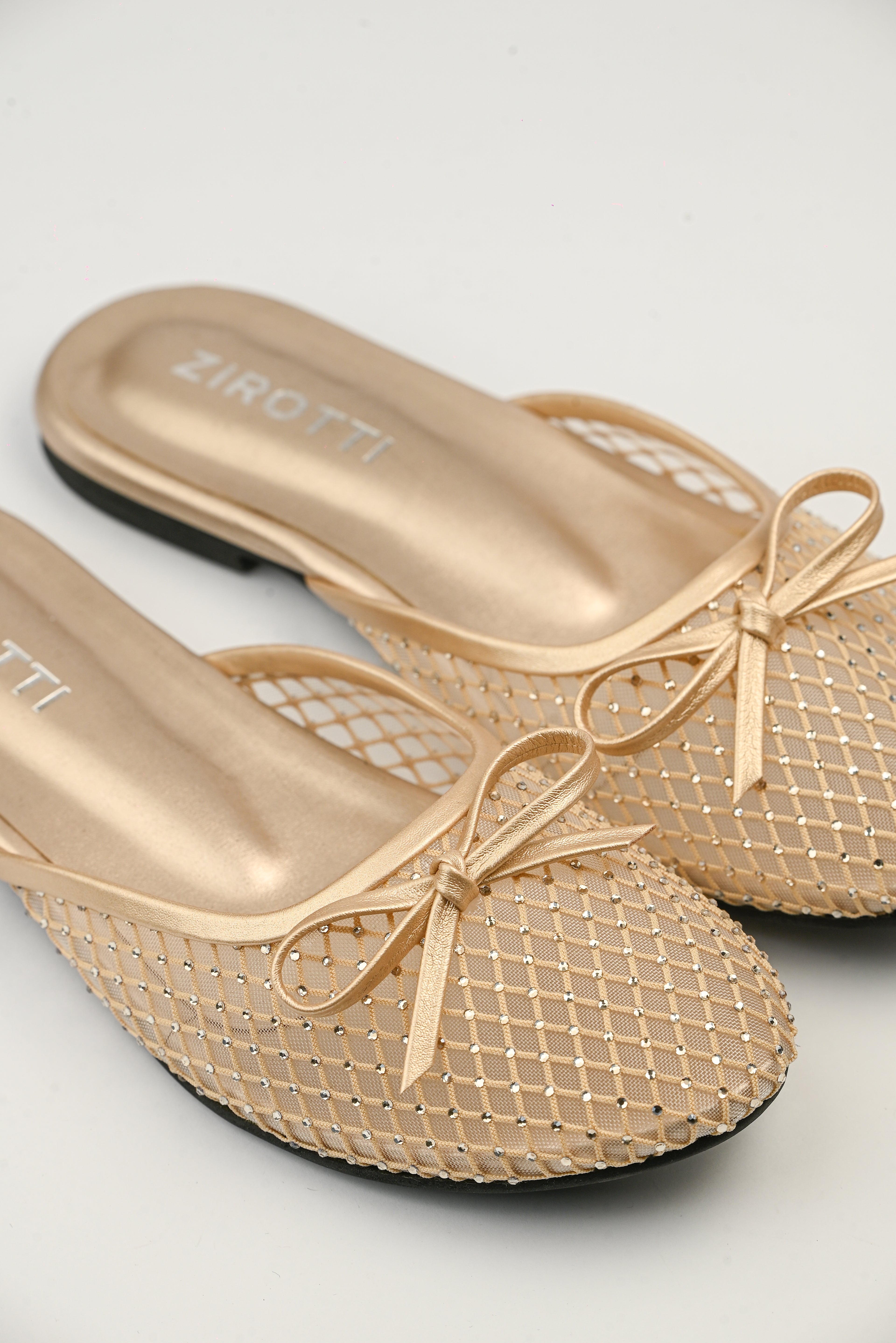 Lunara Gold women’s flat shoes with open design, cushioned insole, and stylish gold finish.