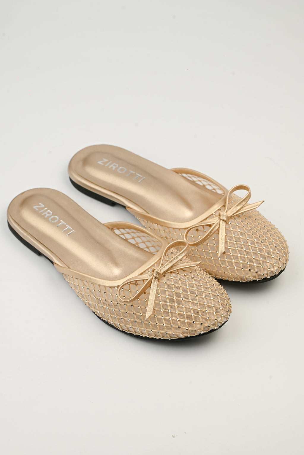 Lunara Gold women’s flat shoes with open design, cushioned insole, and stylish gold finish.