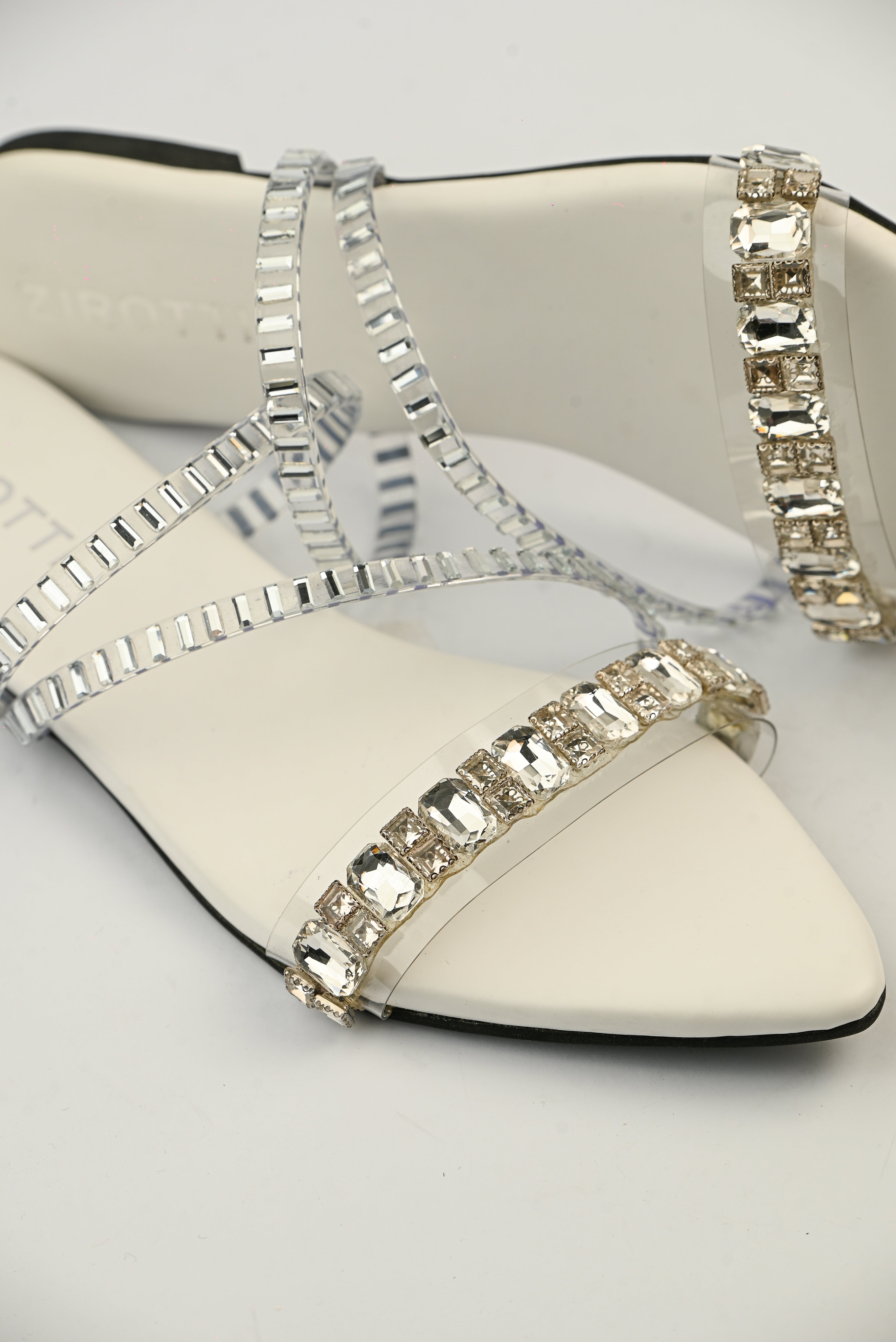 Orvia White women’s flat shoes with stylish stone detailing and comfortable sole.