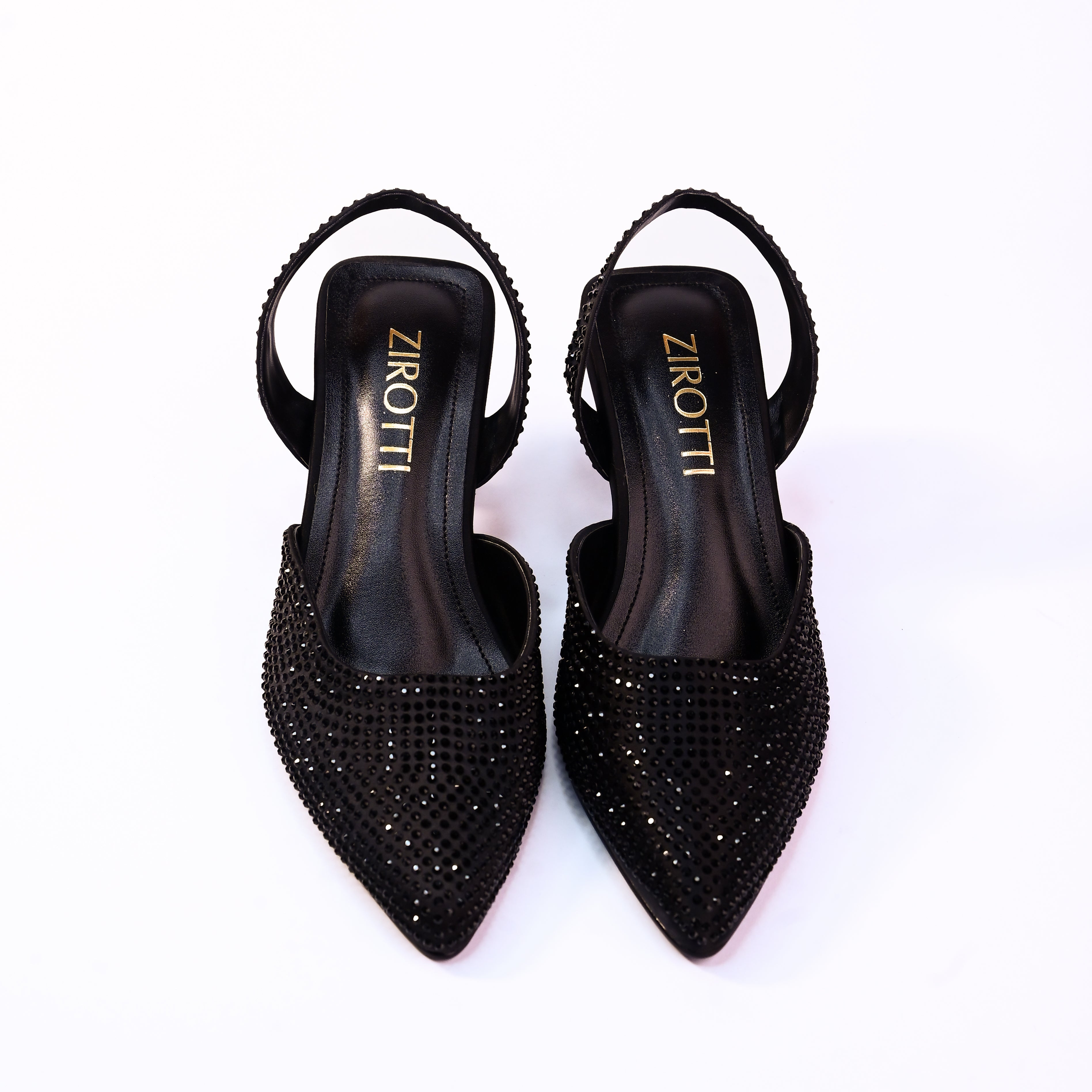 Vyana Black Heel – elegant black sandal featuring a sleek heel, glossy finish, and refined feminine silhouette, designed for formal events and evening wear.