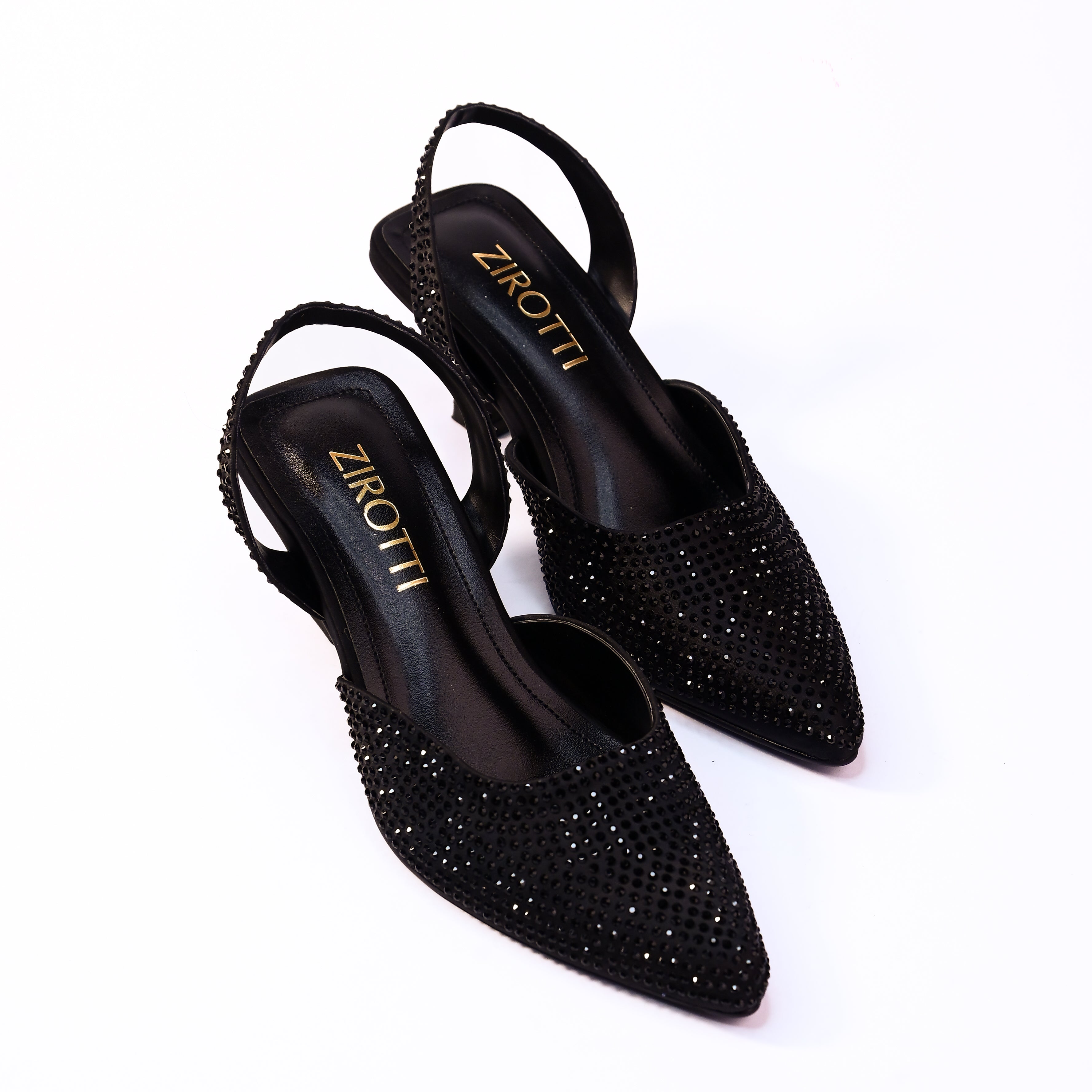 Vyana Black Heel – elegant black sandal featuring a sleek heel, glossy finish, and refined feminine silhouette, designed for formal events and evening wear.