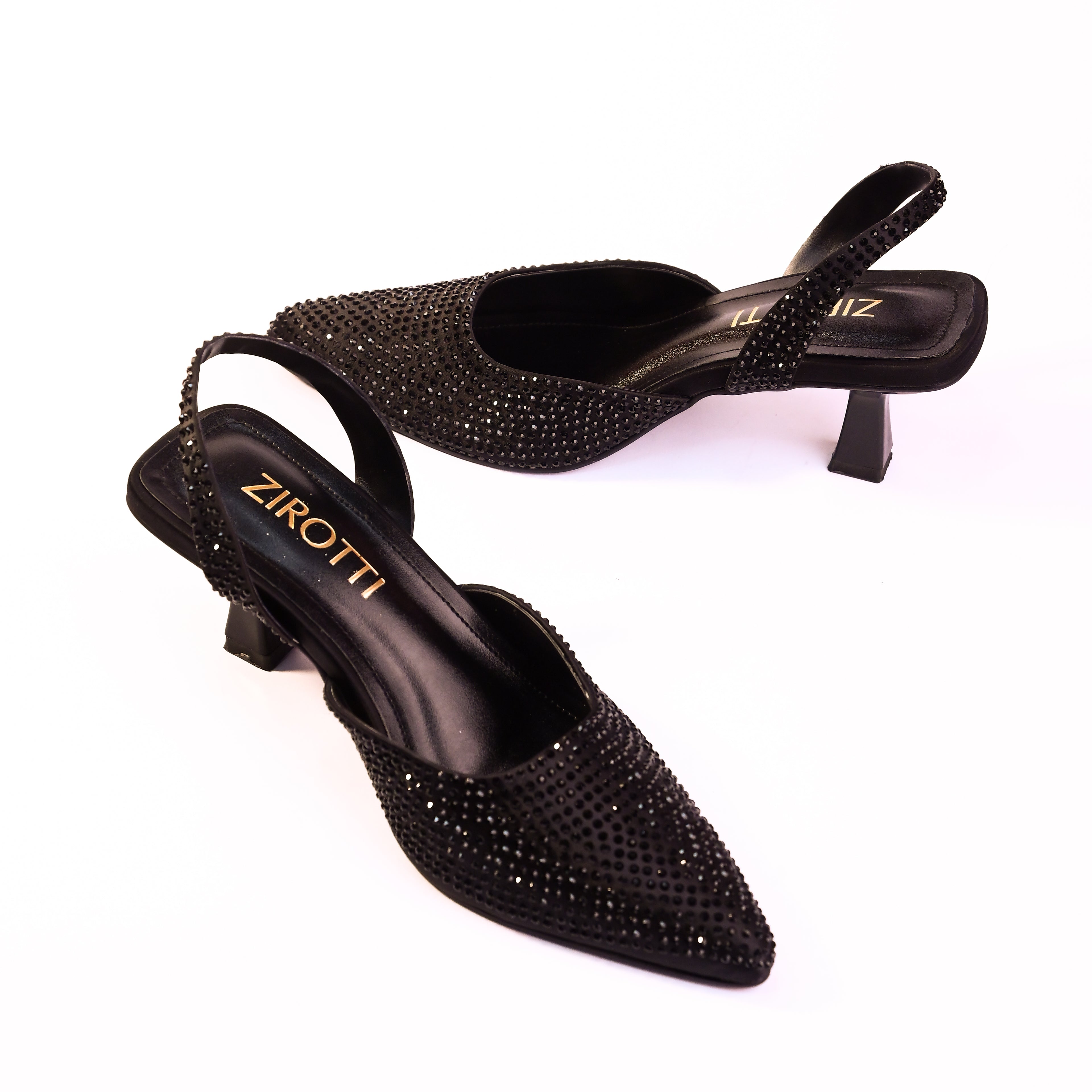 Vyana Black Heel – elegant black sandal featuring a sleek heel, glossy finish, and refined feminine silhouette, designed for formal events and evening wear.