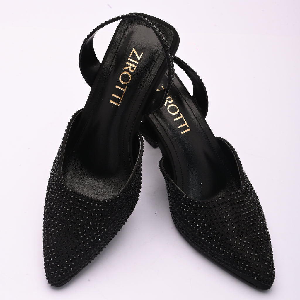 Vyana Black Heel – elegant black sandal featuring a sleek heel, glossy finish, and refined feminine silhouette, designed for formal events and evening wear.
