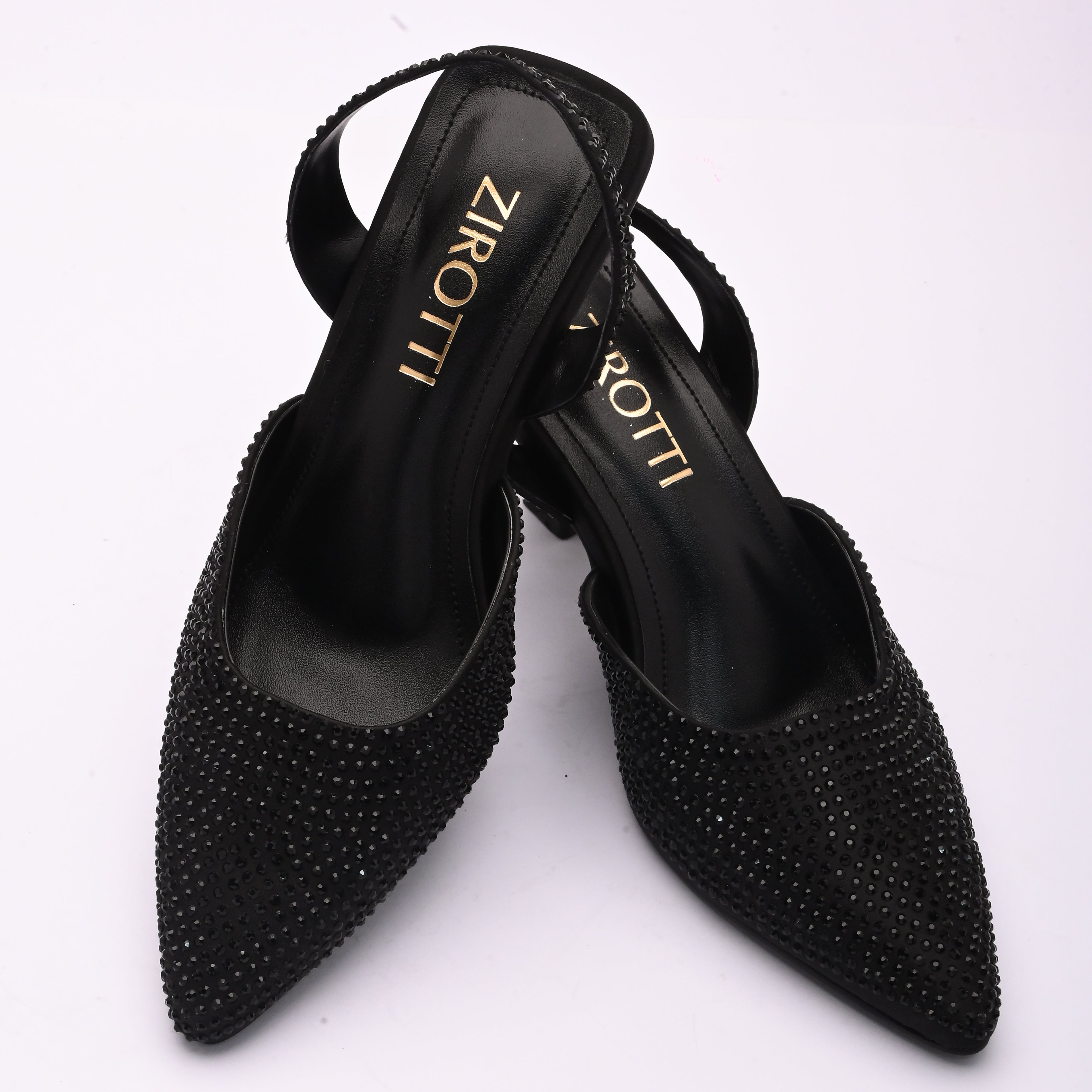 Vyana Black Heel – elegant black sandal featuring a sleek heel, glossy finish, and refined feminine silhouette, designed for formal events and evening wear.