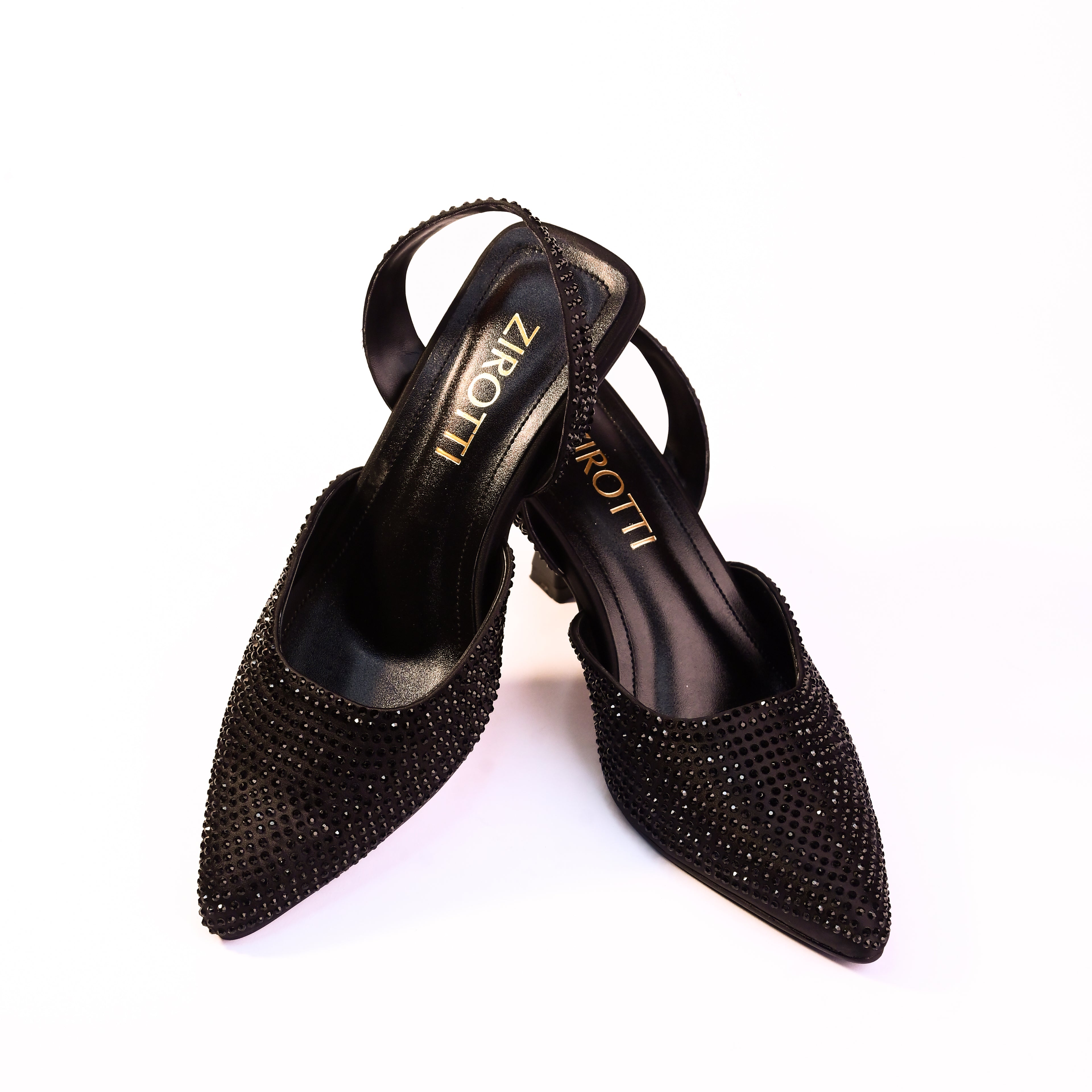 Vyana Black Heel – elegant black sandal featuring a sleek heel, glossy finish, and refined feminine silhouette, designed for formal events and evening wear.