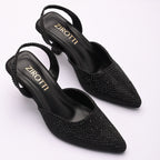 Vyana Black Heel – elegant black sandal featuring a sleek heel, glossy finish, and refined feminine silhouette, designed for formal events and evening wear.