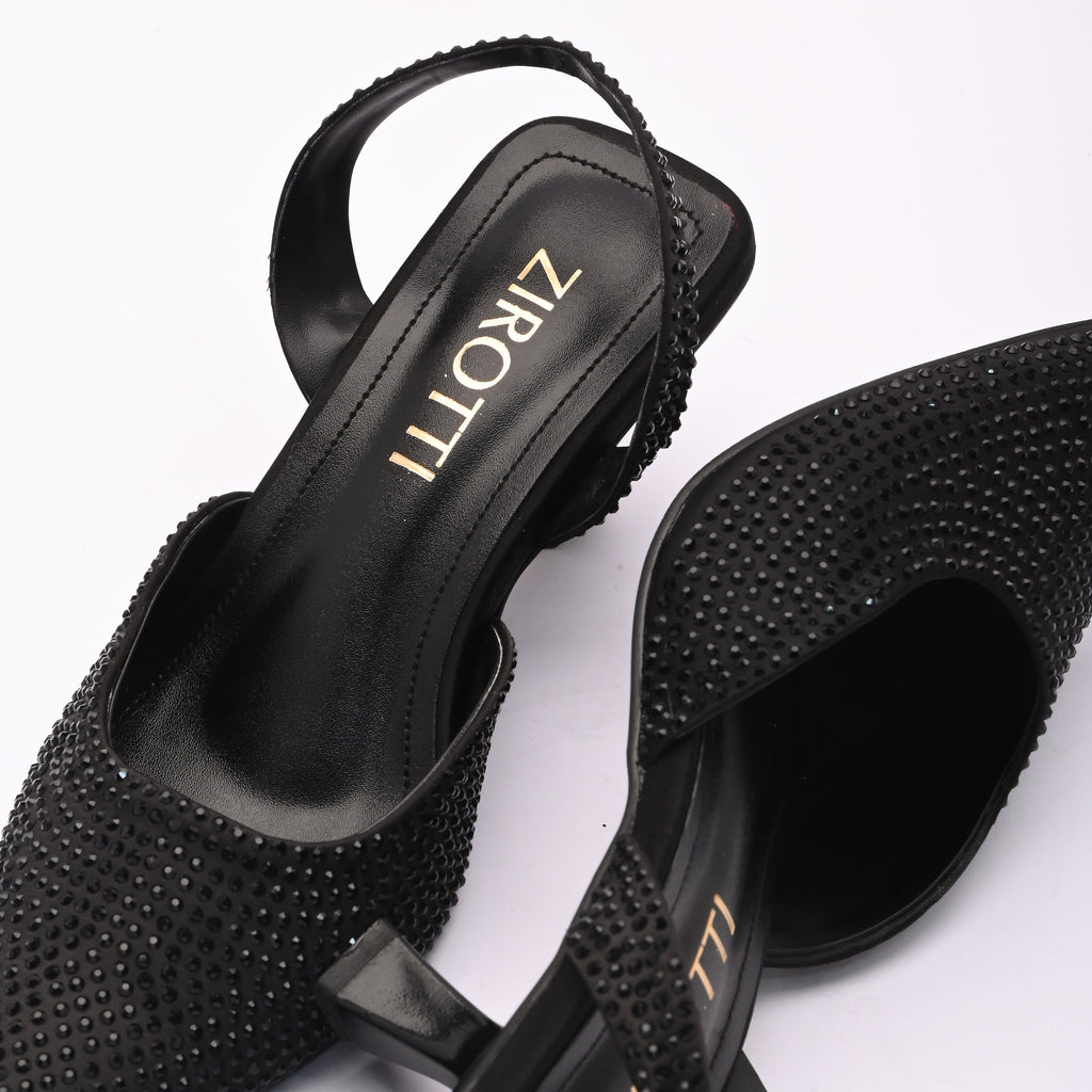 Vyana Black Heel – elegant black sandal featuring a sleek heel, glossy finish, and refined feminine silhouette, designed for formal events and evening wear.