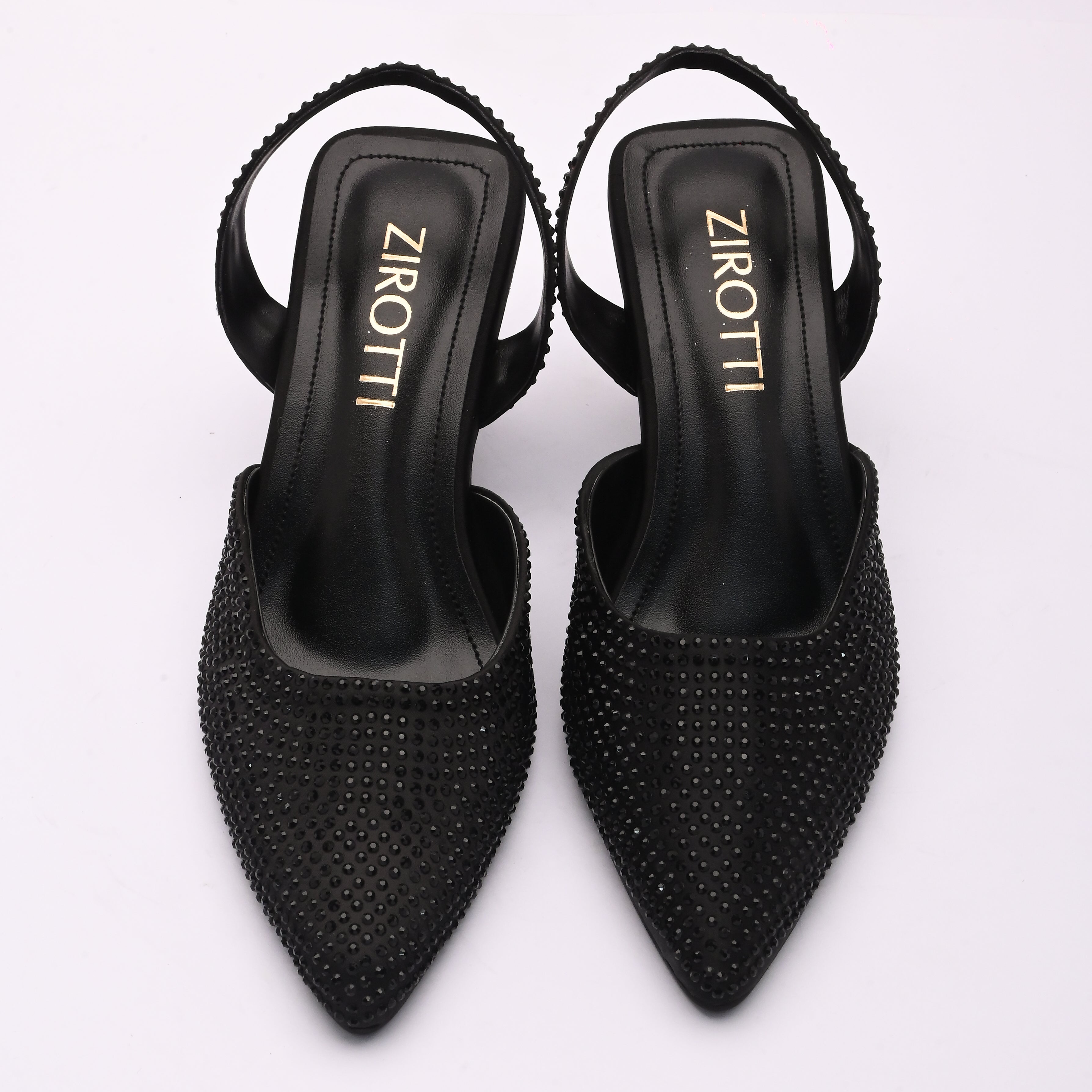 Vyana Black Heel – elegant black sandal featuring a sleek heel, glossy finish, and refined feminine silhouette, designed for formal events and evening wear.